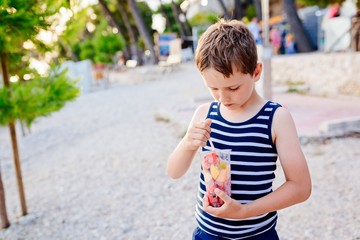 Child eating sliced fruits