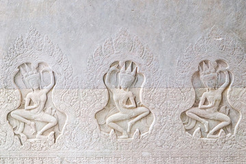 Dancing Apsaras an old Khmer art carvings on the wall in the corridors of Angkor Wat temple near Siem Reap town, Cambodia.