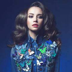 Young woman in jeans with a lot of brooches