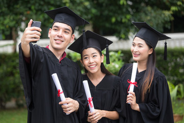 Young Asian Students using Smartphone for Selfie with Friend at University, Students  with Graduation Concept.