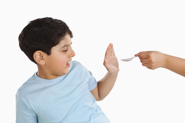 Little boy refusing to take medicine