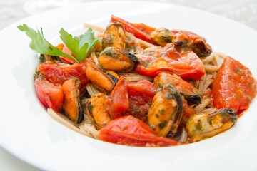 white dish with Pasta spaghetti , mussel and tomatoes