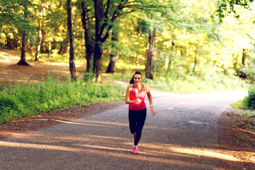 Young woman running in nature.