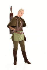 full length portrait of a blonde girl wearing green and brown medieval costume, holding a bow and...