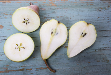 Sweet pears fruit cut in half in the old grungy background