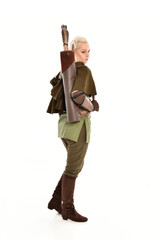 full length portrait of a blonde girl wearing green and brown medieval costume, holding a bow and arrow. isolated on white background.