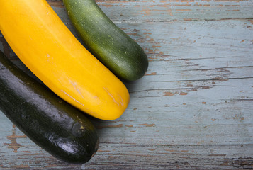 Different color vegetable zucchini on old grungy top