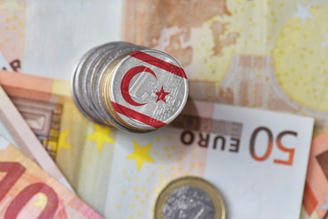 euro coin with national flag of northern cyprus on the euro money banknotes background.