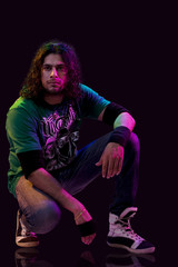 A young man squatting 