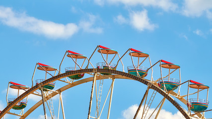 Fototapeta na wymiar Panoramic picture of a Ferris wheel against blue sky.
