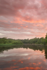 Fototapeta na wymiar Summer landscape scenic fiery sunset over calm river