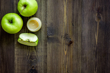 Apple puree for baby on dark wooden table background top view copyspace