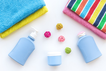Bath accessories. Towels, soap, shampoo, lotion, cream on white background top view