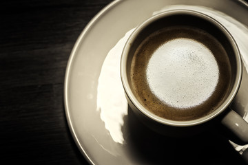 Top view of hot coffee cup on dark background. Food and drink background