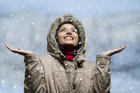 Close-up of young woman enjoying snow 