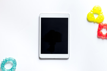 Mockup for adoption concept. Tablet PC near toys on white background top view copyspace