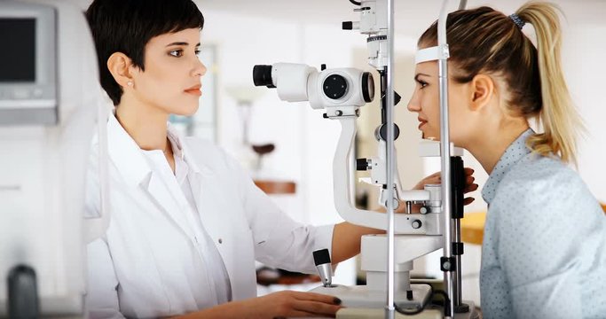 Patient or customer at slit lamp at optometrist or optician
