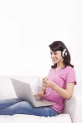 Woman listening to music while having tea