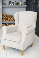 Classic soft armchair near the fireplace