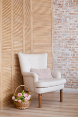 Classic soft armchair near brick wall