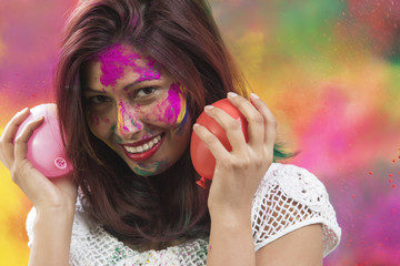 Indian Happy Young Girl With Holi Balloons at Holi Festival