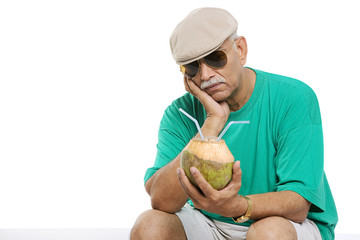 Fototapeta premium Old man with a coconut drink 