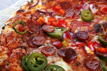 Hot pizza slice with melting cheese on a rustic wooden table. Italien food concept