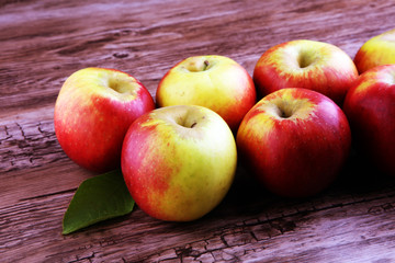 Ripe red apples on wooden background summer concept