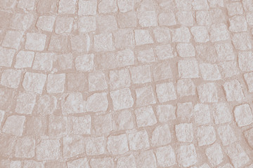 Abstract background of old cobblestone pavement close-up.