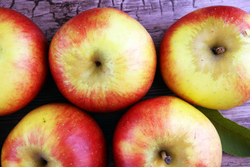 Ripe red apples on wooden background summer concept