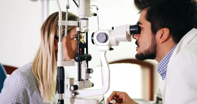 optometrist checking patient eyesight and vision correction