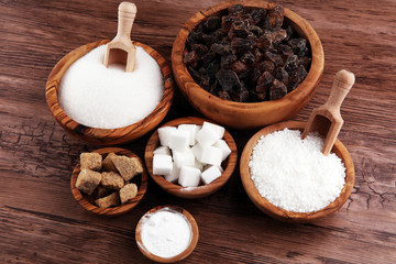 Sugar composition with white and brown sugar on wooden board