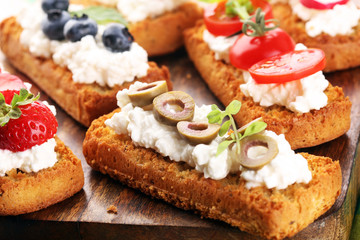 Bread Brushetta or authentic traditional spanish tapas set for lunch table. Sharing antipasti on party or summer picnic time over wooden rustic background.