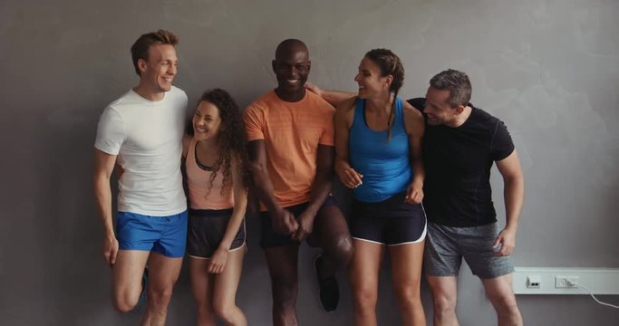 Group of friends laughing together after a gym workout
