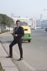 Businessman holding a digital tablet , INDIA , DELHI