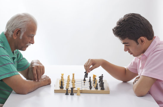 Grandfather and grandson playing chess