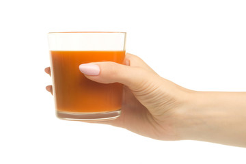 A glass of carrot-apple juice in a woman's hand