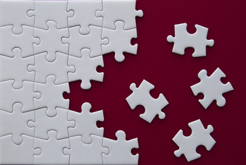 Fototapeta premium Puzzle pieces on red background.