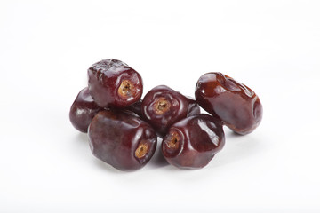 Close-up of tropical date fruits isolated over white background. 