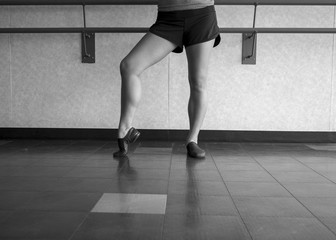 black and white version of Jazz dancer pose with foot in dig