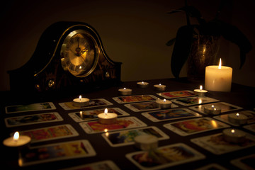 Mystic fortune-telling with fired candles and playing cards in d