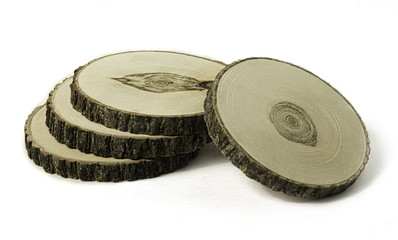 Four round thin wood cuts on white background