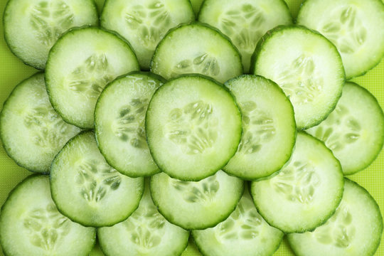 Fresh green slices of cucumber as background