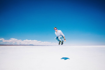 Boy jumping in Uyuni salt flats