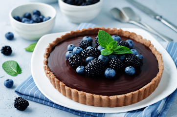 Chocolate tart with blackberries and blueberries.