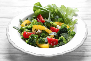 Plate with broccoli salad on wooden table