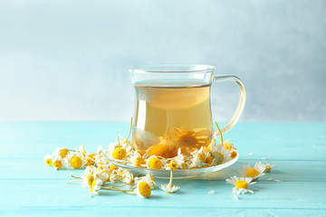Cup of chamomile tea on wooden table