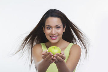 Portrait of woman holding an apple