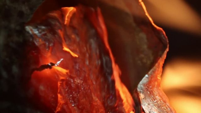 Extreme close up, condom wrapper on fire