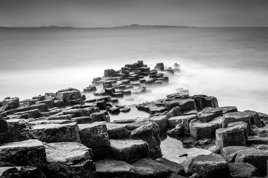Long exposure seascape of basalt columns on the island of Staffa in the Inner Hebrides, Scotland